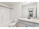 Clean bathroom features a white vanity, toilet, and shower-tub combination at 4967 Zoya Sw Ct, Atlanta, GA 30331