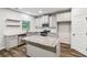 Bright kitchen features granite countertops, an island, stainless steel appliances, and wood flooring at 4967 Zoya Sw Ct, Atlanta, GA 30331