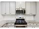 The kitchen features stainless steel appliances, subway tile backsplash, and grey cabinets at 4967 Zoya Sw Ct, Atlanta, GA 30331