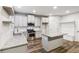 Open concept kitchen with a central island, stainless steel appliances, and a cozy breakfast nook at 4967 Zoya Sw Ct, Atlanta, GA 30331
