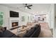 Open concept living room with fireplace, TV, and seamless flow to kitchen at 4967 Zoya Sw Ct, Atlanta, GA 30331