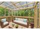Cozy screened-in porch featuring comfortable seating and lush greenery views at 4967 Zoya Sw Ct, Atlanta, GA 30331