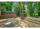 Backyard featuring a wooden deck with mature trees and a charming gazebo at 2173 Tanglewood Ne Trl, Conyers, GA 30013