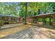 Large deck with gazebo, bench seating and mature trees surrounding the backyard at 2173 Tanglewood Ne Trl, Conyers, GA 30013