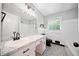Stylish bathroom with a marble countertop, white cabinets, and patterned tile flooring at 2173 Tanglewood Ne Trl, Conyers, GA 30013