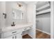 Bathroom featuring a vanity with undermount sink and walk-in closet with storage at 2173 Tanglewood Ne Trl, Conyers, GA 30013