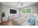 Serene bedroom with neutral colors, a ceiling fan, and plenty of natural light at 2173 Tanglewood Ne Trl, Conyers, GA 30013