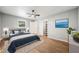 Bright bedroom featuring hardwood floors, a ceiling fan and closet for optimal storage at 2173 Tanglewood Ne Trl, Conyers, GA 30013