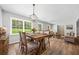 Inviting dining room with a large table, chandelier, and views of the landscaped yard at 2173 Tanglewood Ne Trl, Conyers, GA 30013
