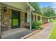 Close-up of the home's entryway showing brick facade and manicured landscaping at 2173 Tanglewood Ne Trl, Conyers, GA 30013