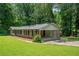 Ranch style home with lush lawn and a two car carport at 2173 Tanglewood Ne Trl, Conyers, GA 30013