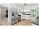 Well-equipped kitchen featuring stainless steel appliances, granite countertops, and white cabinets at 2173 Tanglewood Ne Trl, Conyers, GA 30013