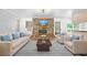 Cozy living room featuring a brick fireplace, modern furniture, and hardwood floors at 2173 Tanglewood Ne Trl, Conyers, GA 30013