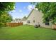 Spacious, well-maintained backyard with a pristine lawn and partial wooden fence at 2685 Gateview Ct, Cumming, GA 30040