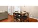 Open-concept dining area with dark wood table, comfortable seating, and natural light at 2685 Gateview Ct, Cumming, GA 30040