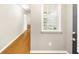 Bright hallway featuring hardwood floors and natural light from a window at 2685 Gateview Ct, Cumming, GA 30040