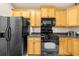 Kitchen with stainless steel appliances, light wood cabinets, and granite countertops at 2685 Gateview Ct, Cumming, GA 30040