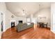Open-concept living room with fireplace, dining area, and hardwood floors at 2685 Gateview Ct, Cumming, GA 30040