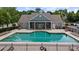 Community pool area showcasing pool, seating, and the adjacent clubhouse, promoting relaxation at 2685 Gateview Ct, Cumming, GA 30040
