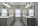 Bathroom with dual vanities, large mirrors, and modern fixtures at 3018 Patriot Square, Marietta, GA 30064
