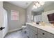 Bright bathroom features a white quartz countertop, gray cabinetry, and a mirror at 3018 Patriot Square, Marietta, GA 30064