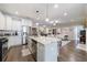 Modern kitchen featuring a large island, stainless steel appliances, and white cabinets at 3018 Patriot Square, Marietta, GA 30064