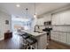 Open kitchen with granite island and seating that flows into the dining room at 3018 Patriot Square, Marietta, GA 30064