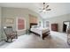 Spacious main bedroom with vaulted ceiling, rocking chair and comfortable bed at 3018 Patriot Square, Marietta, GA 30064