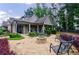 Charming home with a stone patio featuring a stone fire pit and bench seating at 3018 Patriot Square, Marietta, GA 30064