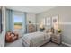 Inviting bedroom with a bed, dresser, nightstands, beanbag chair, and a window with scenic views at 5451 Baybrook Cir, South Fulton, GA 30349