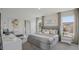 Serene bedroom with two windows, neutral bedding, curtains, and minimalist decor at 5451 Baybrook Cir, South Fulton, GA 30349