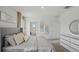 Sleek bedroom featuring a bed, and a dresser with decorative mirror, lending to a contemporary aesthetic at 5451 Baybrook Cir, South Fulton, GA 30349