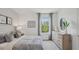 Stylishly furnished bedroom with a neutral color palette and a large window with green views at 5451 Baybrook Cir, South Fulton, GA 30349