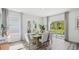 Elegant dining room with a modern table, chairs, and sliding glass door to outside at 5451 Baybrook Cir, South Fulton, GA 30349