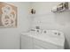 Bright laundry area featuring a Whirlpool washer and dryer set and wire rack shelving at 5451 Baybrook Cir, South Fulton, GA 30349