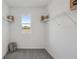 Spacious walk-in closet with shelving, window, and carpeted flooring at 5451 Baybrook Cir, South Fulton, GA 30349