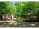 Fenced backyard featuring a trampoline, a storage shed and mature trees at 210 Evans Dr, Decatur, GA 30030