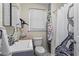 Small bathroom with combined shower and tub, single sink and storage shelves at 210 Evans Dr, Decatur, GA 30030