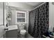 Cozy bathroom featuring a sink, toilet, and tub/shower combo with modern patterned shower curtain at 210 Evans Dr, Decatur, GA 30030