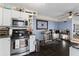 Cozy kitchen features stone tile floor, stainless steel appliances and eat in breakfast area at 210 Evans Dr, Decatur, GA 30030