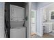Convenient laundry closet with a stacked washer and dryer setup, adjacent to a half bath at 210 Evans Dr, Decatur, GA 30030