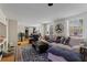 Open-concept living room with a cozy sofa, hardwood floors, and abundant natural light at 210 Evans Dr, Decatur, GA 30030
