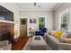 Bright living room with brick fireplace, hardwood floors, and large windows at 210 Evans Dr, Decatur, GA 30030