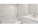 Modern all-white bathroom features a shower-tub combo, vanity with sink, and minimalist design at 5449 Baybrook Cir, South Fulton, GA 30349