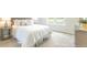 Comfortable bedroom with a large bed, side tables, and a view of the outdoors at 5449 Baybrook Cir, South Fulton, GA 30349