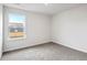 Bedroom with neutral gray carpet, white walls, and a window overlooking neighborhood at 5449 Baybrook Cir, South Fulton, GA 30349