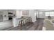 Open concept kitchen with granite countertops, stainless steel appliances, and bar stool seating at 5449 Baybrook Cir, South Fulton, GA 30349