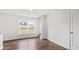Bright living room with hardwood floors, white walls, view of the yard, and doorway to stairs at 5449 Baybrook Cir, South Fulton, GA 30349