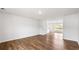 Bright living room with hardwood floors, white walls, and ample natural light from a window at 5449 Baybrook Cir, South Fulton, GA 30349