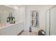 Modern bathroom with double sink vanity, framed mirror and glass-enclosed shower at 5455 Baybrook Cir, South Fulton, GA 30349